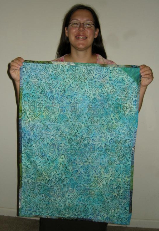 Jen holding up the back of the finished Tree Art Quilt - 9-09