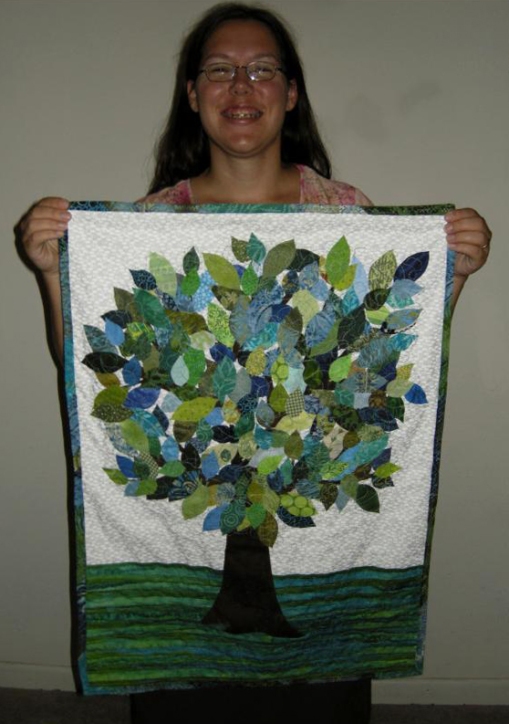 Jen holding up the finished Tree Art Quilt - 9-09