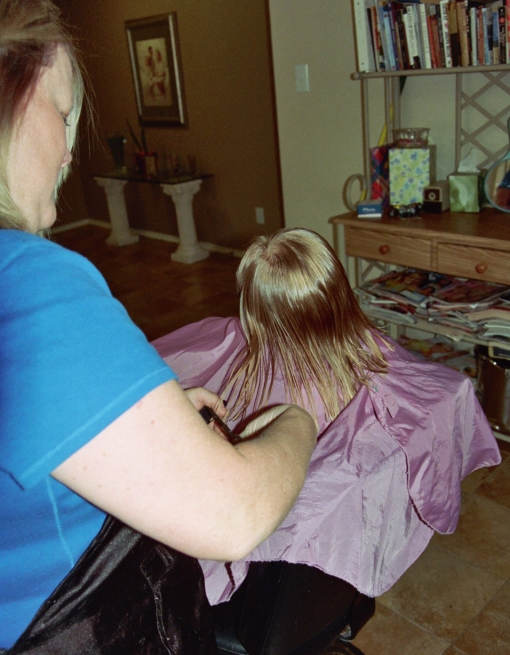 Miss Karen cutting Elianas hair - 09-08-09