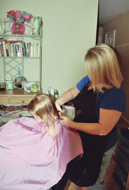 Miss Karen making the first cut on Elianas hair - 9-08-09